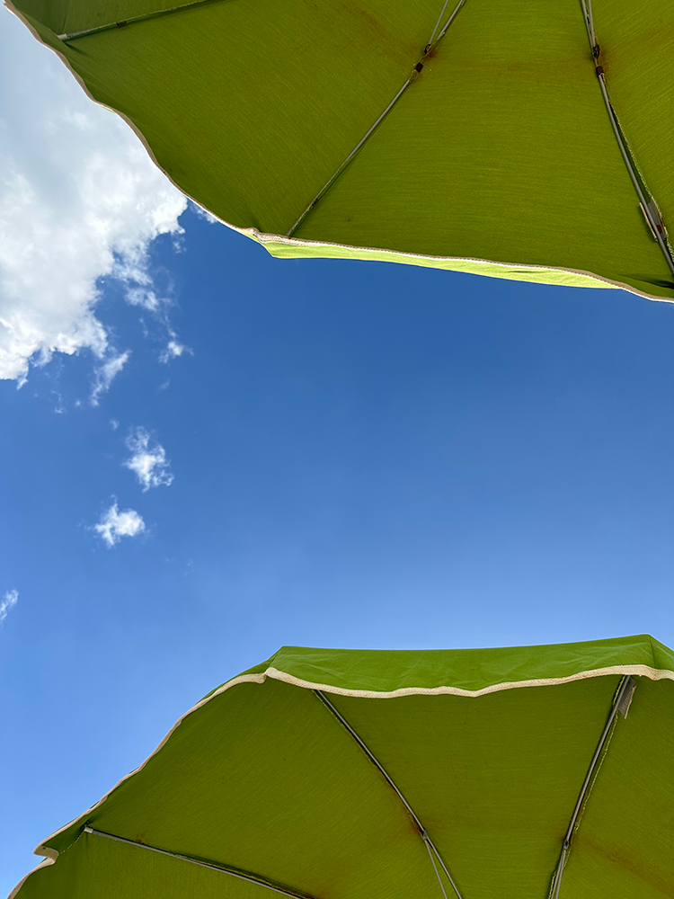 Amazing blue sky through the umbrellas